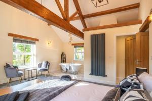 a bedroom with a bathroom with a tub and a sink at High Brow Edge Farm Cottage in Backbarrow