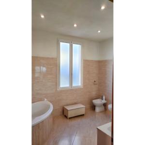 a bathroom with a tub and a sink and a toilet at Affittacamere Les chambres in Chiavari +31 photos