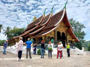 a group of people standing in front of a building at Villa Deux Rivières Hotel in Luang Prabang