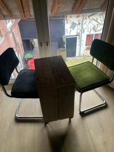 two chairs and a table in front of a window at Althuizenhof - Leem in Doenrade