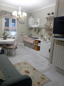a kitchen with a table and a dining room at Casa Alex in Cascina