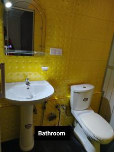 a bathroom with a sink and a toilet and a mirror at Thames Villa Galle in Hapugala +9 photos