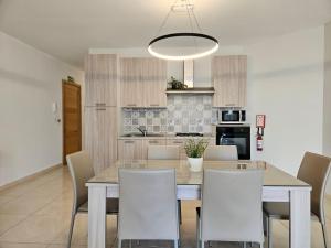 a kitchen and dining room with a table and chairs at SeaLine in St. Paul's Bay