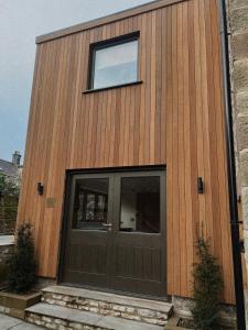 a building with a door and a window on it at Stock Barn in Youlgreave