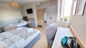 a small room with two beds and a couch at Villa Rosa in Stronie Śląskie