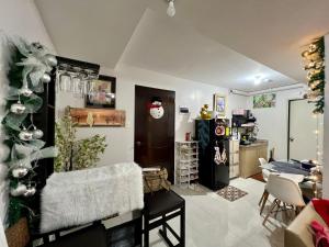 a living room with a christmas tree and a kitchen at Affordable Condominium in Cebu in Cebu City