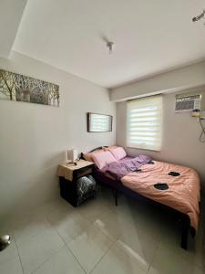 Ένα ή περισσότερα κρεβάτια σε δωμάτιο στο Affordable Condominium in Cebu