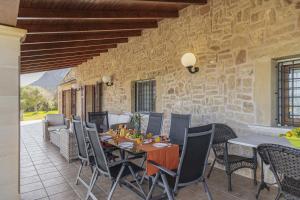 a dining room with a table and chairs on a patio at Villa Las Comas de Dalt in Alcudia