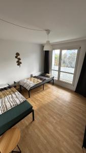 a bedroom with two beds and a large window at 13 Apartments 3BR R&P Living in Halle an der Saale +145 photos