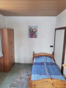 a bedroom with a bed with a picture of a dog on the wall at Ferienwohnung am Backhaus 2 in Weimar