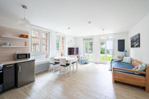 a kitchen and living room with a table and a couch at Horní Mísečky - I3 Pohodlný a teplý apartmán u sjezdovky in Horni Misecky