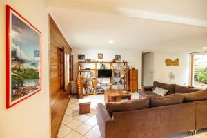 a living room with a couch and a table at La Kaz Pomme Cannelle in Rivière