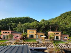 a row of houses in front of a mountain at 비우리게스트하우스 in Kujŏm