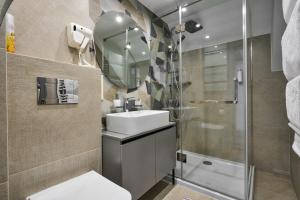 a bathroom with a sink and a shower at Hotel Velyka Vedmedytsya in Yaremche +97 photos