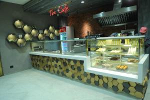 a bakery counter with a display case with pastries at The Harilal in Patna