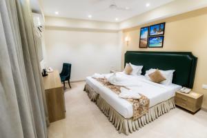 a hotel room with a bed and a chair at Hotel Flora in Male City +78 photos