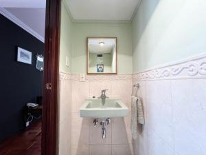 a bathroom with a sink and a mirror at Soleado departamento con vistas hermosas Sopocachi in La Paz +23 photos