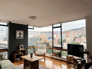 a living room with a view of a city at Soleado departamento con vistas hermosas Sopocachi in La Paz