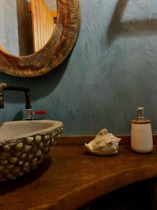 a bathroom with a sink and a mirror on a counter at Village Choça in Acaraú +63 photos