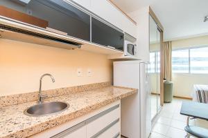 a kitchen with a sink and a refrigerator at Saint Moritz Hotel em Brasília 91641 in Brasilia +18 photos