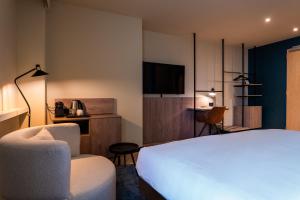 Postel nebo postele na pokoji v ubytování Golden Tulip Leiden Centre