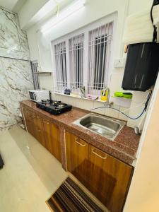 a kitchen with a sink and a counter top at VANDYaS INN 1BHK Studio Unit in Guwahati