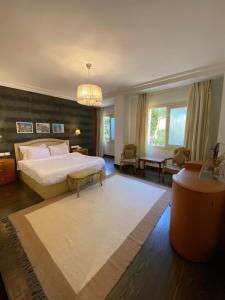a bedroom with a bed and a living room at One Sixteen Guest House in Sheikh Zayed