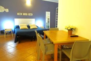 a bedroom with a bed and a table with chairs at Vibes 5terre in Riomaggiore
