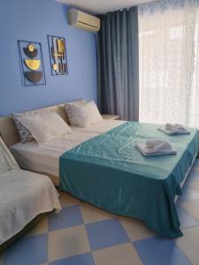 a bedroom with two beds with towels on them at Apartments Victoria in Kranevo