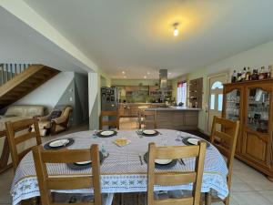 a kitchen and dining room with a table and chairs at La Maison de la Tuffiere - 14pers - Circuit Bugatti in Le Grand-Lucé