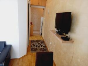 a living room with a television on a wall at B4 in Budva