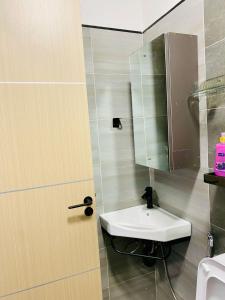 a bathroom with a sink and a mirror at Kozy Homes in Nairobi +9 photos