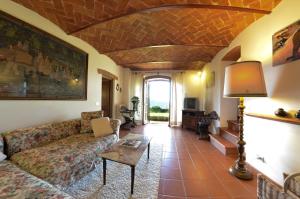 a living room with a couch and a table at Villa Eugenio in Cortona