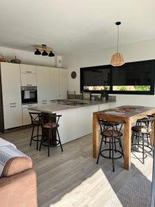 a kitchen and living room with a table and chairs at Casa di Cortanni in Castellare-di-Casinca +26 photos