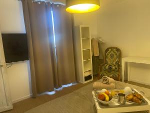 a room with a table with a tray of fruit on it at Chambre d'Hôtes la Familia in Marseillan +12 photos