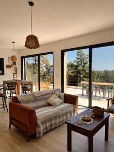 a living room with a couch and a table at Casa di Cortanni in Castellare-di-Casinca
