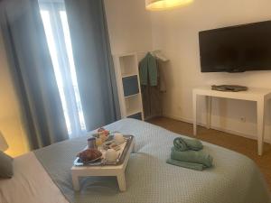 a bedroom with a tray of food on a bed at Chambre d'Hôtes la Familia in Marseillan