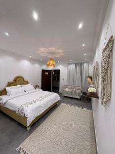 a bedroom with a large bed and a chandelier at Al Damany Desert camp &Villa in Dubai