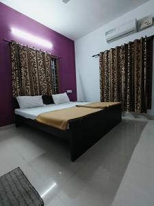 a bedroom with a large bed in a room at Volare villa in Cochin +5 photos