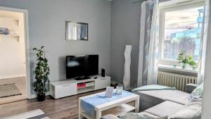 a living room with a flat screen tv on a table at Vöyrinkadun Viihtyisä - Free WiFi and Parking in Vaasa