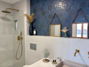 a bathroom with a shower and a sink and a mirror at El Mirador de NaLi - accès direct à la plage in Arenal d'en Castell +37 photos