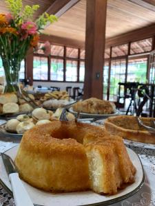 a table topped with different types of cakes and pies at Hotel Pierazzo in Santa Teresa