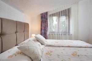 a bedroom with a bed and a window at Apartment Roce in Rabac