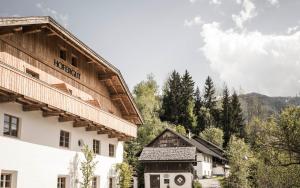a building with a sign that reads hotel at HOFERGUT Suites & Apartments in Riscone