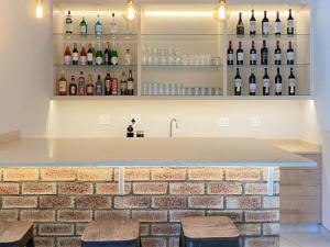 a bar with bottles of wine on the wall at The Grand Comfort in Rustenburg