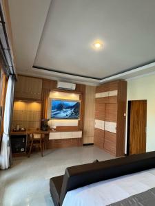 a living room with a bed and a desk at The Kanha Palace in Nusa Penida