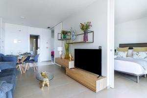 a living room with a tv and a couch at Intempo by Holuxe - 036 - 3rd floor in Benidorm
