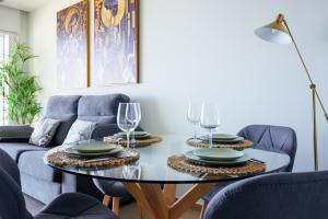 a living room with a table and chairs at Intempo by Holuxe - 036 - 3rd floor in Benidorm
