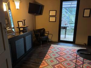 a living room with a large door and a rug at Zeller Kehr Wohnung in Zell an der Mosel