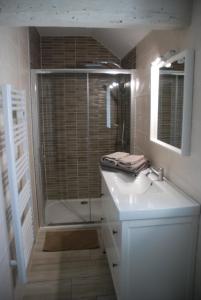 a bathroom with a white sink and a shower at Le CLOS MARATUEL in Sarlat-la-Canéda +12 photos